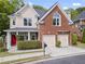 Charming two-story home with a brick facade, two-car garage, and manicured landscaping at 2462 Chestnut Lndg, Atlanta, GA 30360