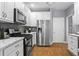 Well-equipped kitchen featuring stainless steel appliances, modern countertops, and ample cabinet space at 2462 Chestnut Lndg, Atlanta, GA 30360