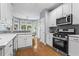 Bright kitchen with white cabinets, stainless steel appliances, and hardwood floors at 2462 Chestnut Lndg, Atlanta, GA 30360