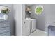 Well-organized laundry room with washer, dryer, and octagon window offering natural light and serene views at 2462 Chestnut Lndg, Atlanta, GA 30360