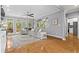 Spacious living room featuring hardwood floors, a plush sofa, and abundant windows at 2462 Chestnut Lndg, Atlanta, GA 30360