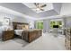 Spacious main bedroom featuring a tray ceiling, neutral carpet, and large windows at 2462 Chestnut Lndg, Atlanta, GA 30360