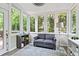 Bright sunroom featuring large windows, a cozy couch, and tasteful decor at 2462 Chestnut Lndg, Atlanta, GA 30360