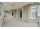 Covered balcony features white wood floors, arched windows and doors, and recessed lighting at 1079 Arbor Ne Trce, Atlanta, GA 30319