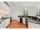 Spacious kitchen bar with granite countertops, wine cooler, and stainless steel sink at 1079 Arbor Ne Trce, Atlanta, GA 30319