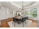 Bright dining room featuring hardwood floors, modern chandelier and an abundance of natural light from large windows at 1079 Arbor Ne Trce, Atlanta, GA 30319