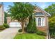 Charming brick home showcasing a well-maintained lawn and brick driveway leading to a two-car garage at 1079 Arbor Ne Trce, Atlanta, GA 30319