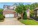 Beautiful brick home with a paver driveway, manicured lawn, and mature trees enhancing curb appeal at 1079 Arbor Ne Trce, Atlanta, GA 30319