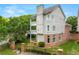 Exterior elevation of the home with multiple balconies, brick foundation, and well-manicured landscaping at 1079 Arbor Ne Trce, Atlanta, GA 30319