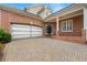 Expansive brick driveway leading to a two-car garage and covered entry, showcasing classic design elements at 1079 Arbor Ne Trce, Atlanta, GA 30319