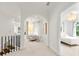 Hallway showcasing an archway, white walls and carpet and peek into a bedroom with bright windows at 1079 Arbor Ne Trce, Atlanta, GA 30319
