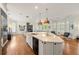 Kitchen island with seating and a view into the adjacent living room, featuring stainless appliances and marble countertops at 1079 Arbor Ne Trce, Atlanta, GA 30319