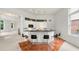Bright kitchen featuring white cabinetry, a black countertop, and a cozy breakfast bar with modern stools at 1079 Arbor Ne Trce, Atlanta, GA 30319