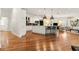 Open-concept kitchen and living area with hardwood floors and a central island with pendant lighting at 1079 Arbor Ne Trce, Atlanta, GA 30319