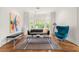 Stylish living room featuring hardwood floors, modern furniture, and ample natural light through the large windows at 1079 Arbor Ne Trce, Atlanta, GA 30319