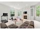 Spacious living room featuring a fireplace with built-in shelving, exercise equipment, and bay windows at 1079 Arbor Ne Trce, Atlanta, GA 30319