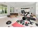 Open living space featuring exercise equipment, modern sofa, and adjacent kitchen area at 1079 Arbor Ne Trce, Atlanta, GA 30319