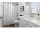 Bathroom featuring white cabinets, vinyl flooring, and shower tub at 29 Laurelwood Nw Ln, Cartersville, GA 30121