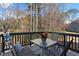 Wooden deck with chairs, glass table, and tree-lined view at 29 Laurelwood Nw Ln, Cartersville, GA 30121