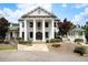 Stately white brick home with grand columns, decorative shingles and manicured landscaping at 29 Laurelwood Nw Ln, Cartersville, GA 30121