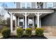 Inviting front porch with white columns, cozy seating, and manicured landscaping, perfect for relaxing outdoors at 29 Laurelwood Nw Ln, Cartersville, GA 30121