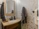 The bathroom is decorated with wallpaper and a brown vanity at 346 M J Mccarthy Way, Hampton, GA 30228