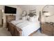 Well-lit bedroom featuring a decorative wooden bed frame, neutral colors, and a view of a doorway at 346 M J Mccarthy Way, Hampton, GA 30228