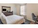 Bedroom with comfortable chair and desk, bright window and large mirror at 346 M J Mccarthy Way, Hampton, GA 30228