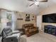 Bright bonus room featuring a leather loveseat, grey recliner, vaulted ceiling, and natural light at 346 M J Mccarthy Way, Hampton, GA 30228