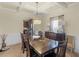A dining room showcases a dark wood table and chairs set, decorative chandelier, and built-in buffet at 346 M J Mccarthy Way, Hampton, GA 30228
