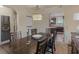A dining area shows wainscoting detail, archways, a statement chandelier, and an adjacent gameroom at 346 M J Mccarthy Way, Hampton, GA 30228