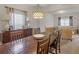 An inviting dining room with hardwood table, chandelier, natural light, and access to the living room at 346 M J Mccarthy Way, Hampton, GA 30228