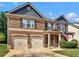 Charming two-story brick home with a two-car garage, porch and an American flag at 346 M J Mccarthy Way, Hampton, GA 30228