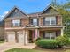 Beautiful two-story brick home featuring a covered porch and well-maintained front yard at 346 M J Mccarthy Way, Hampton, GA 30228