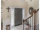 Inviting foyer with sidelights, decorative mirror, wooden staircase and coat closet at 346 M J Mccarthy Way, Hampton, GA 30228