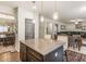 An open concept kitchen with a view of the dining and living areas, plus an island with seating at 346 M J Mccarthy Way, Hampton, GA 30228