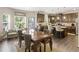 An open concept kitchen with stainless appliances, center island with seating, and adjacent living area at 346 M J Mccarthy Way, Hampton, GA 30228