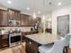 A kitchen with stainless appliances, custom cabinets, pendant lighting, and a center island at 346 M J Mccarthy Way, Hampton, GA 30228