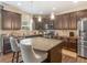 A modern kitchen with stainless appliances, granite counters, a center island, and barstool seating at 346 M J Mccarthy Way, Hampton, GA 30228