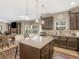 A kitchen with stainless appliances, granite counters, a center island, and barstool seating at 346 M J Mccarthy Way, Hampton, GA 30228