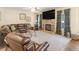 Cozy living area with plush seating, fireplace, ceiling fan, and adjacent to the dining area at 346 M J Mccarthy Way, Hampton, GA 30228