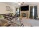 Living room with soft carpet, leather seating, fireplace, media center, and access to other rooms at 346 M J Mccarthy Way, Hampton, GA 30228
