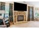 Open concept living area with fireplace, floral drapes, media center, and view to back deck at 346 M J Mccarthy Way, Hampton, GA 30228