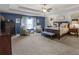 Large main bedroom featuring blue accent wall, tray ceiling, and furniture at 346 M J Mccarthy Way, Hampton, GA 30228