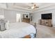 Spacious main bedroom showcases a tray ceiling, media center, and cozy seating area at 346 M J Mccarthy Way, Hampton, GA 30228