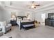 Spacious main bedroom with a tray ceiling, ceiling fan, dark wood furniture, and neutral carpet at 346 M J Mccarthy Way, Hampton, GA 30228