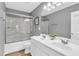 Bathroom featuring a double sink vanity, framed mirror, and shower at 6350 Lantana Village Way, Cumming, GA 30028