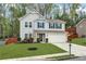 Charming two-story home with a well-manicured lawn and a two car garage at 6350 Lantana Village Way, Cumming, GA 30028