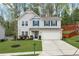 Charming two-story home with a well-manicured lawn and a two-car garage, showcasing curb appeal at 6350 Lantana Village Way, Cumming, GA 30028
