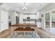 Well-lit kitchen with white cabinets, stainless steel appliances, and a dining area at 6350 Lantana Village Way, Cumming, GA 30028